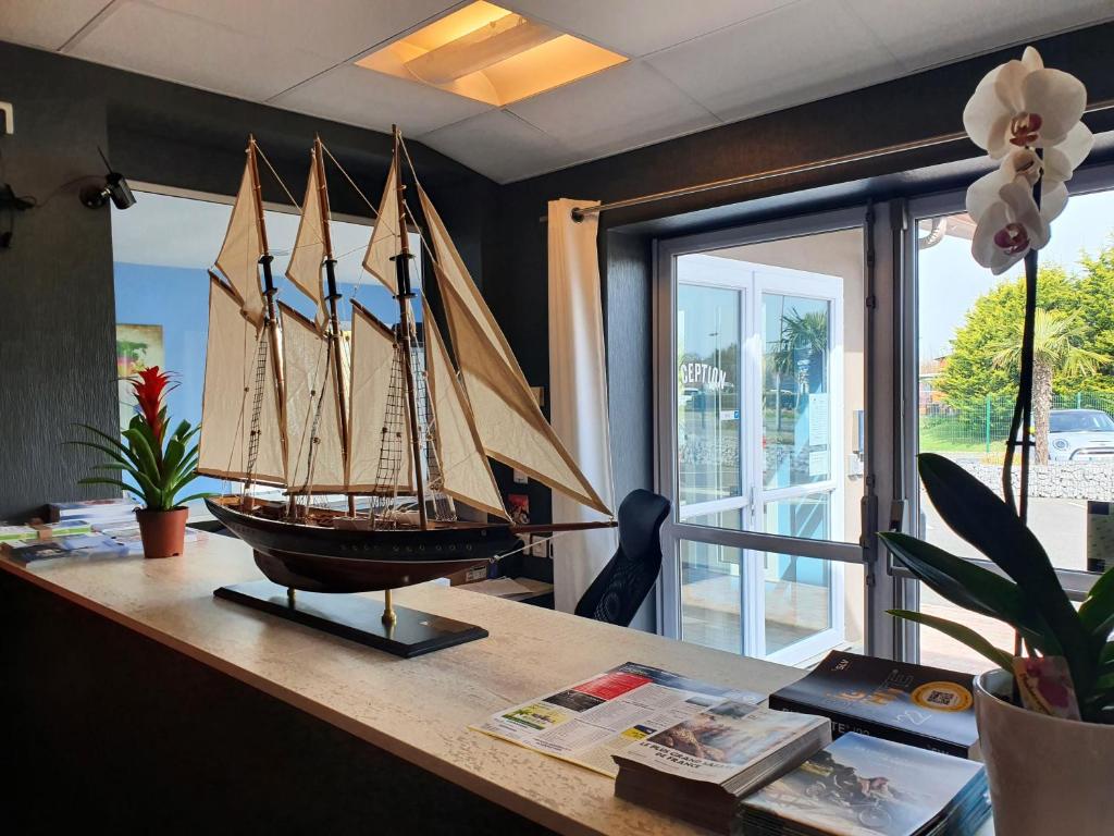 a model ship on a table in a room at Hotel Salea in Pornic
