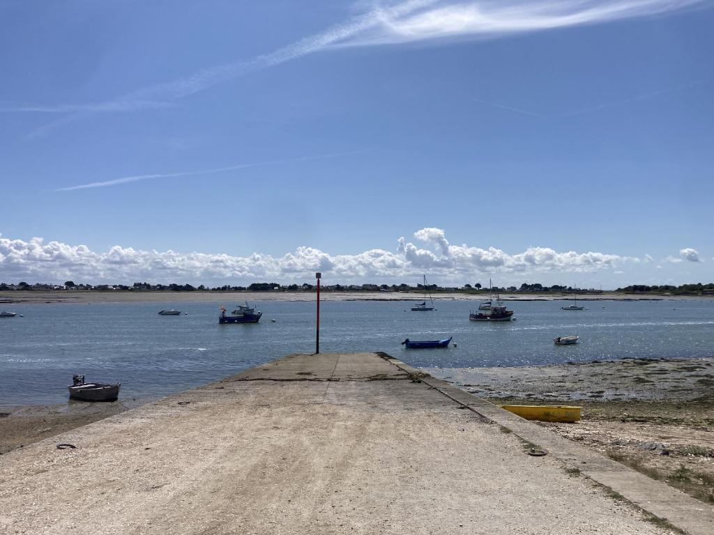 a group of boats sitting in the water at Parenthese relaxante les pieds dans l eau in Le Tour-du-Parc