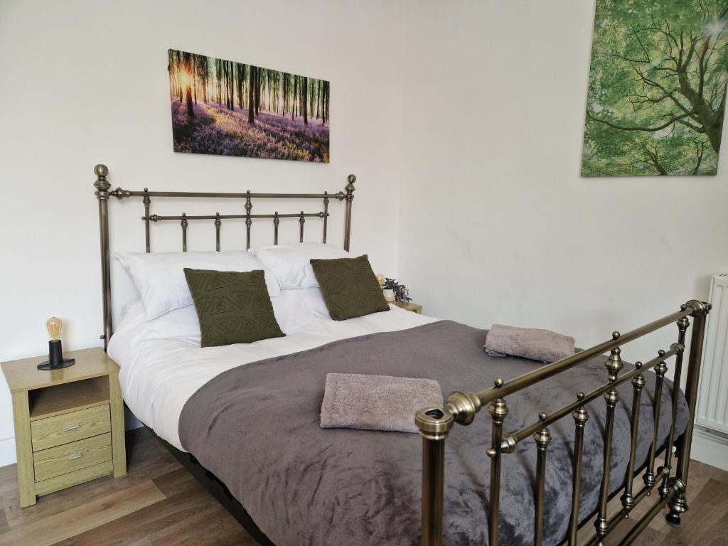 a bedroom with a large bed with a metal frame at Direct Booking Prices, Studio Apartment, Free Parking, Wifi, Central, Quiet in Exeter
