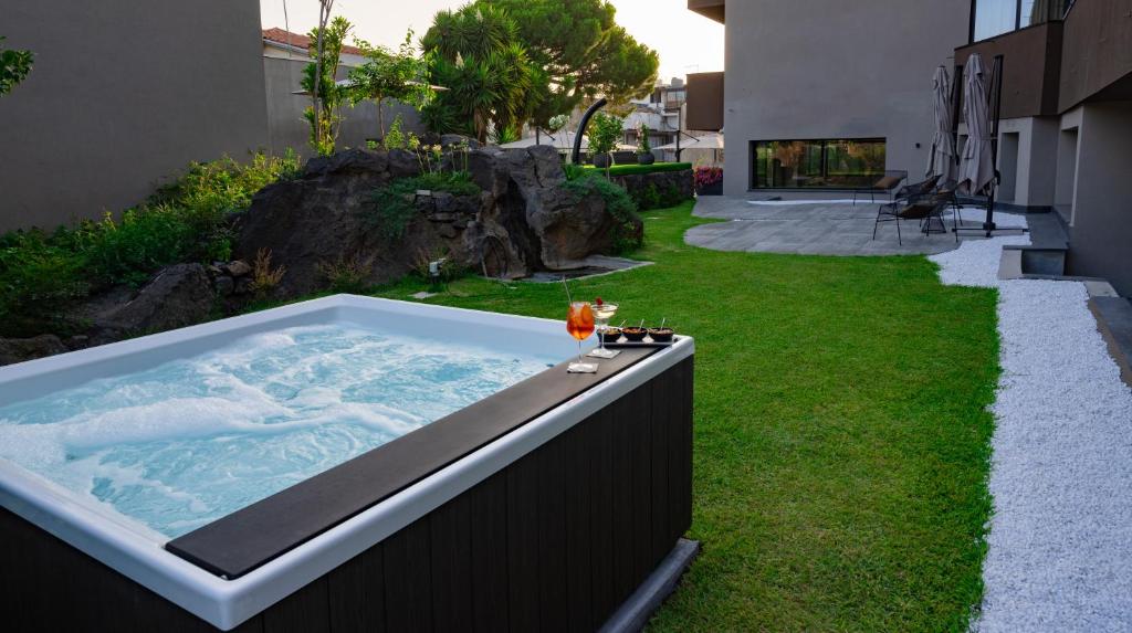 a jacuzzi tub in the backyard of a house at Ollen apartments in Catania