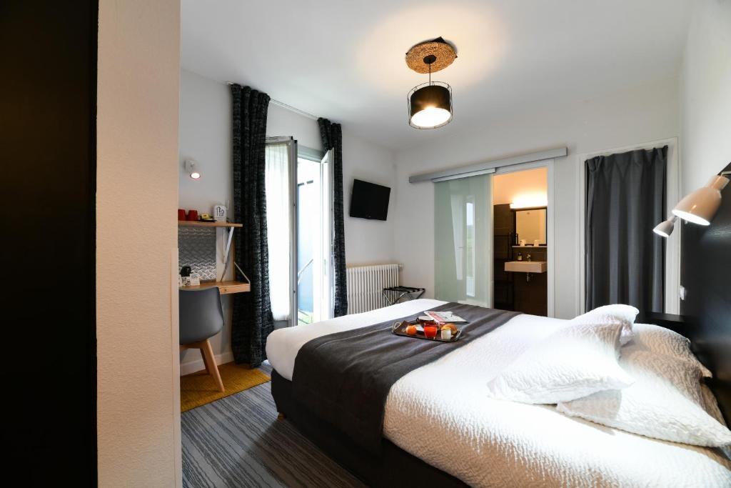 Letto o letti in una camera di Hôtel Le Loft