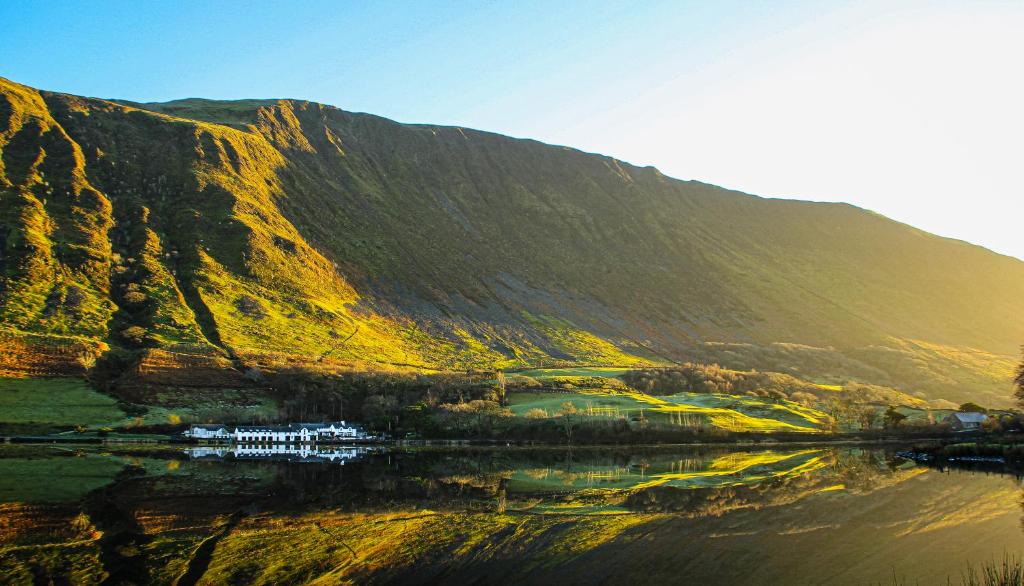 a mountain with a reflection of a body of water at Tynycornel Hotel in Tal-y-llyn