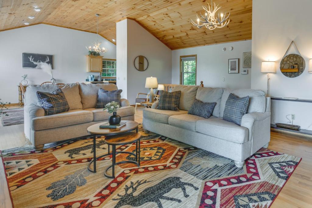 a living room with a couch and a table at Mtn-View Escape with Hot Tub, 9 Mi to Skiing! in Maggie Valley