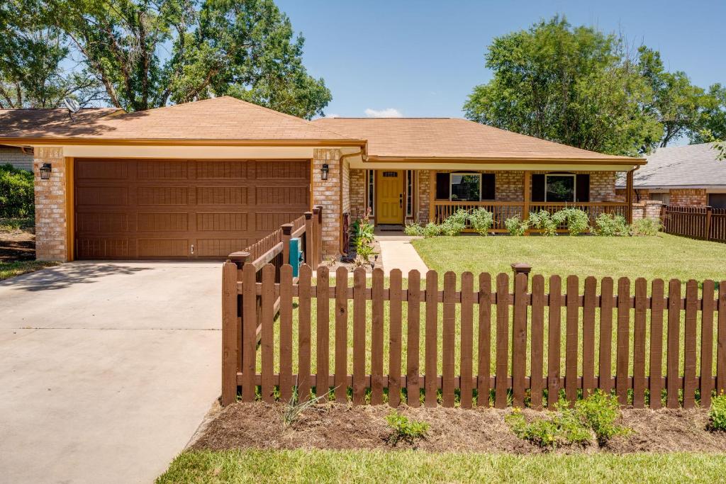 a wooden fence in front of a house at San Antonio Home with Private Hot Tub Pets Welcome! in San Antonio