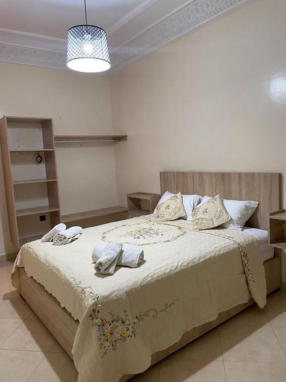 a bedroom with a large bed with towels on it at Logement entier : Appartement à Agadir in Agadir