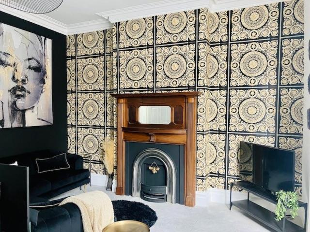 a living room with a fireplace and a tv at Paradise Street Apartment 2 Bed Ground Floor in Rhyl