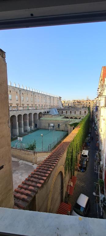 a view of a building with a pool in a courtyard at La casa del Professore in Naples