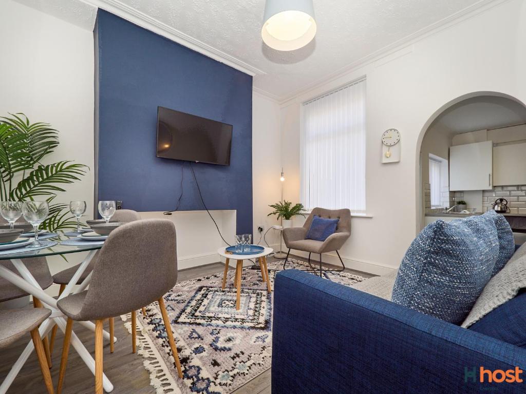 a living room with a blue accent wall at Host Liverpool - Smithdown Hub, Shops & Eats, by centre in Liverpool