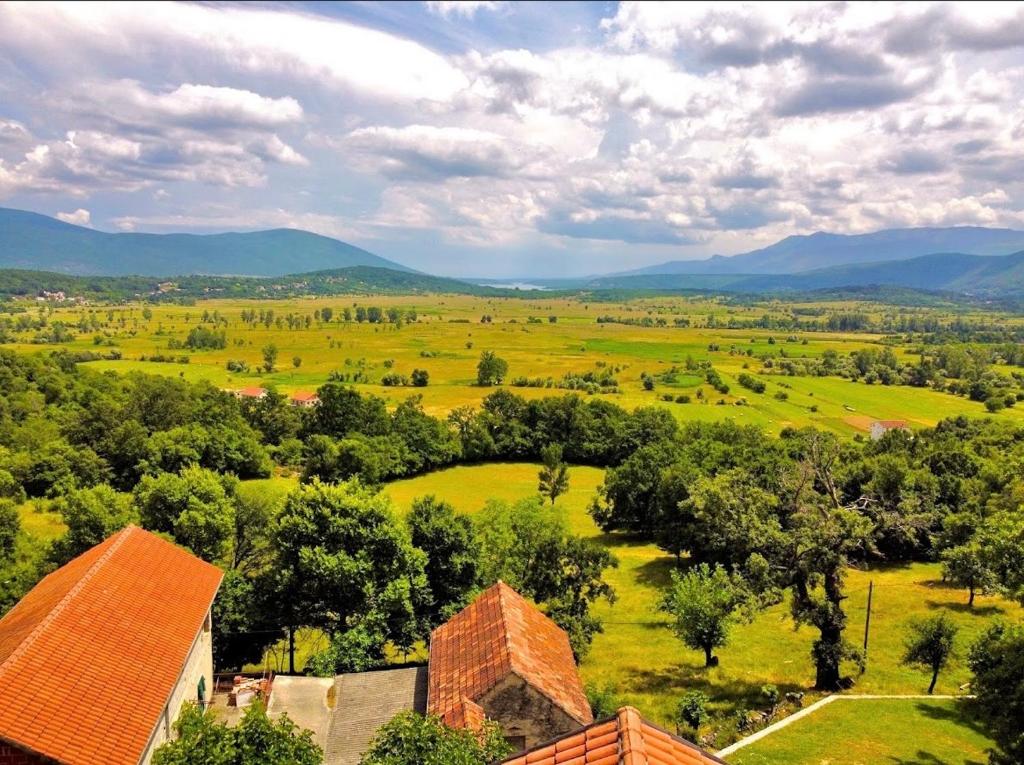 an aerial view of a field with trees and a house at Apartman ANA in Vrlika