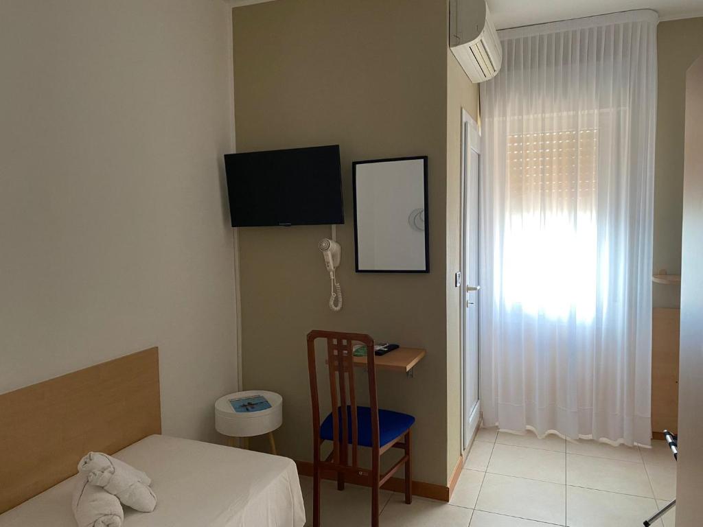 A bed or beds in a room at Hotel Hc Resort Lignano