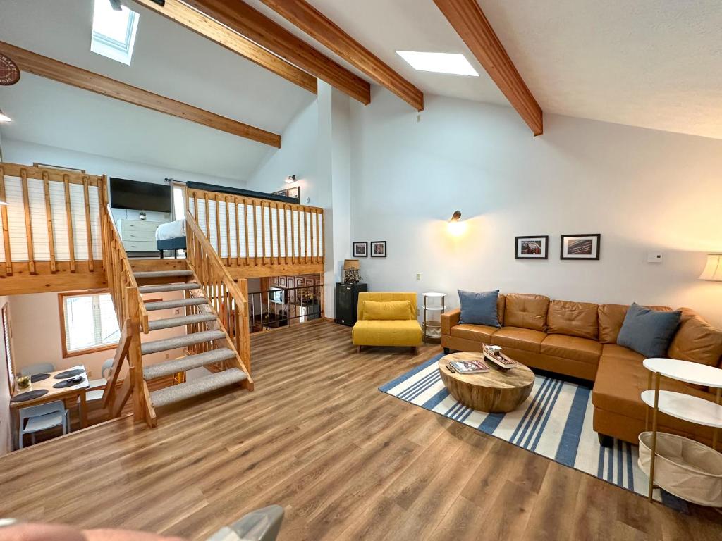a living room with a couch and a staircase at Fun Family Home near Cedar Point in Sandusky