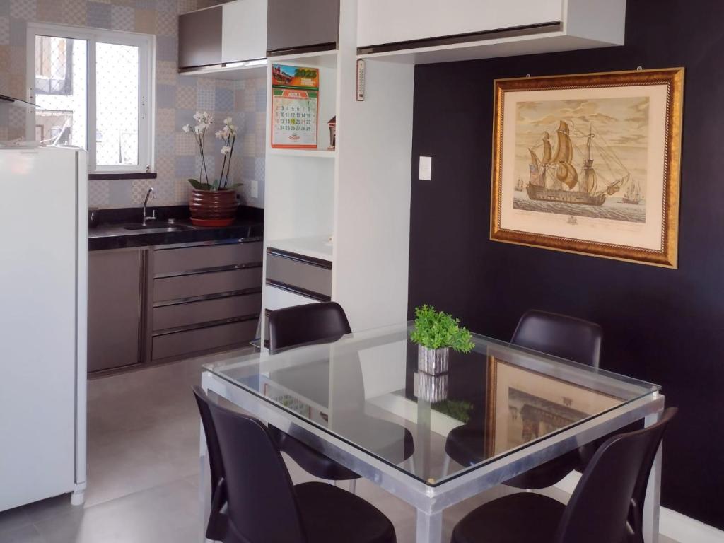 a dining room with a glass table and chairs at Hotel Três Caravelas in Fortaleza