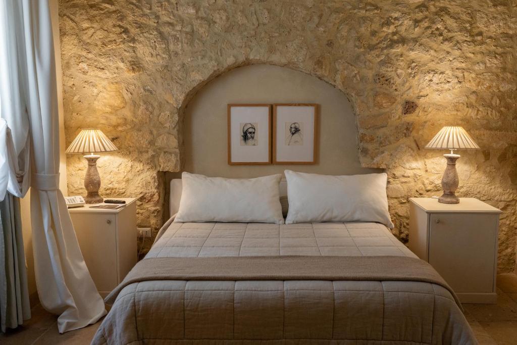 Postel nebo postele na pokoji v ubytování Castello Camemi