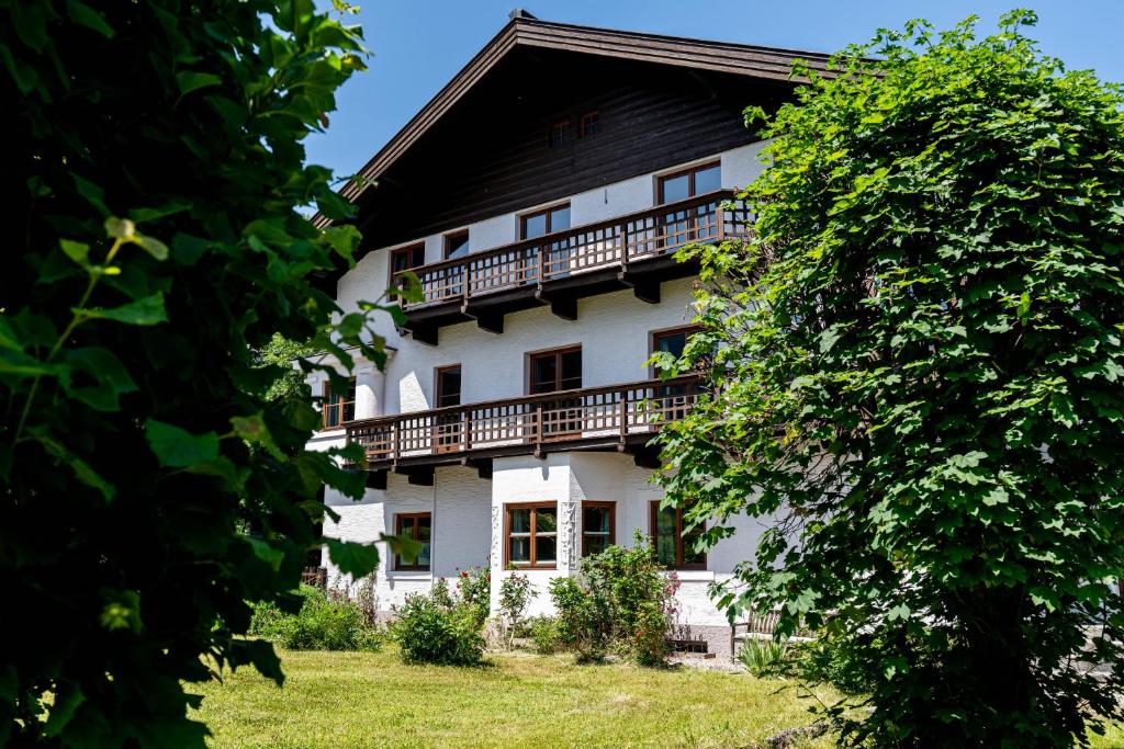 a large white building with a black roof at City Center Rooms Kitzbühel in Kitzbühel