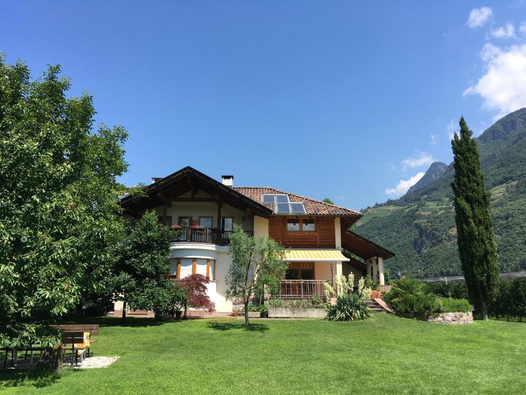 a large house with mountains in the background at Feldererhof in Postal