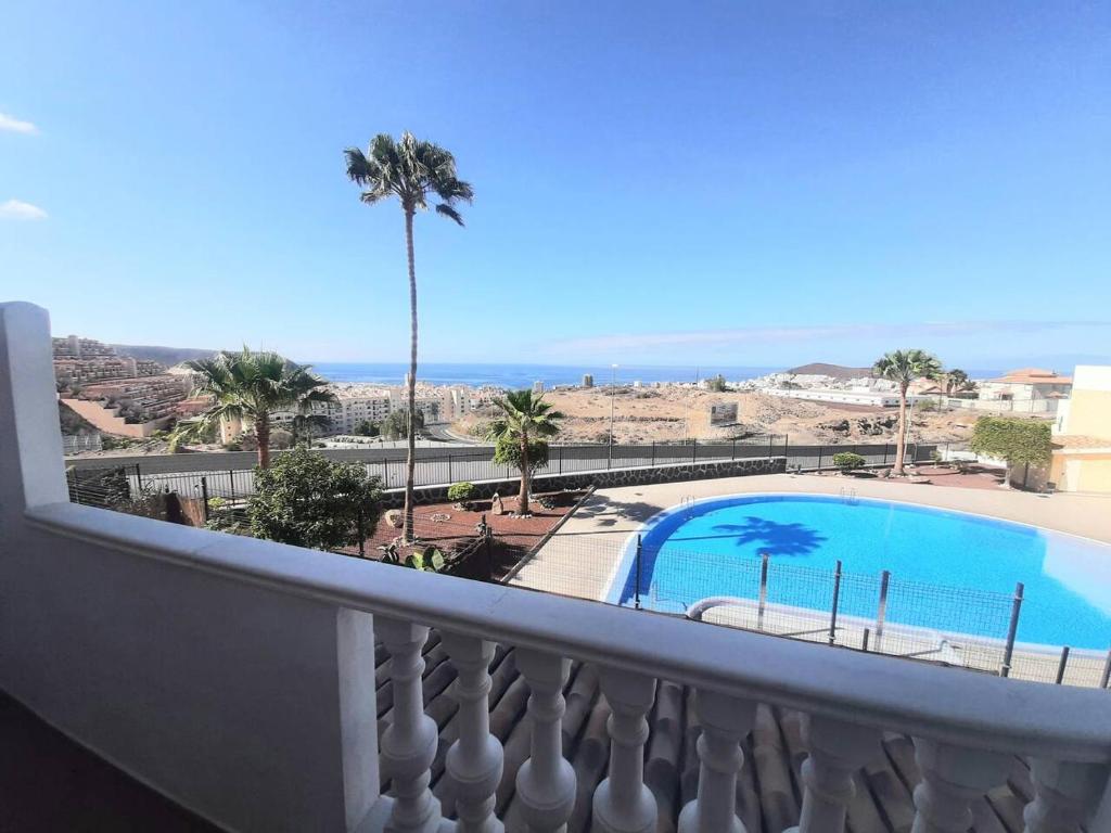 balcón con vistas a la piscina y al océano en 1 bedroom Giuly sea views in Los Cristianos en Los Cristianos