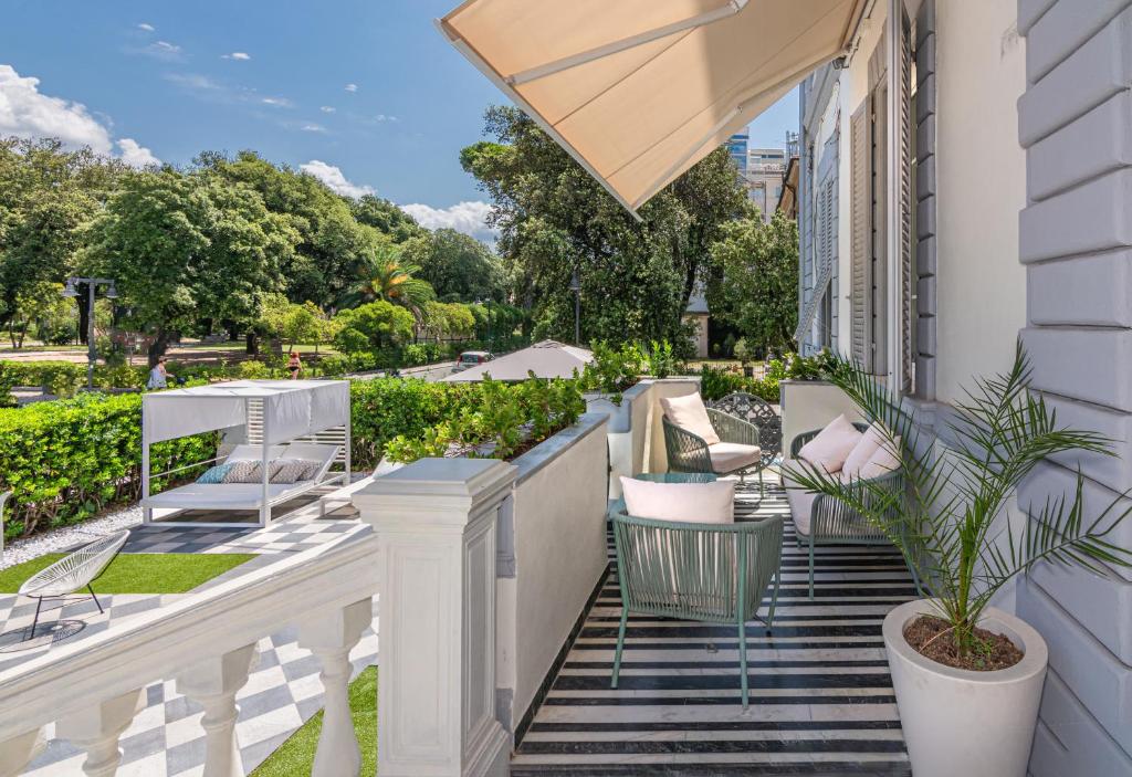 a balcony of a house with chairs and a plant at Hotel Tirreno in Marina di Massa