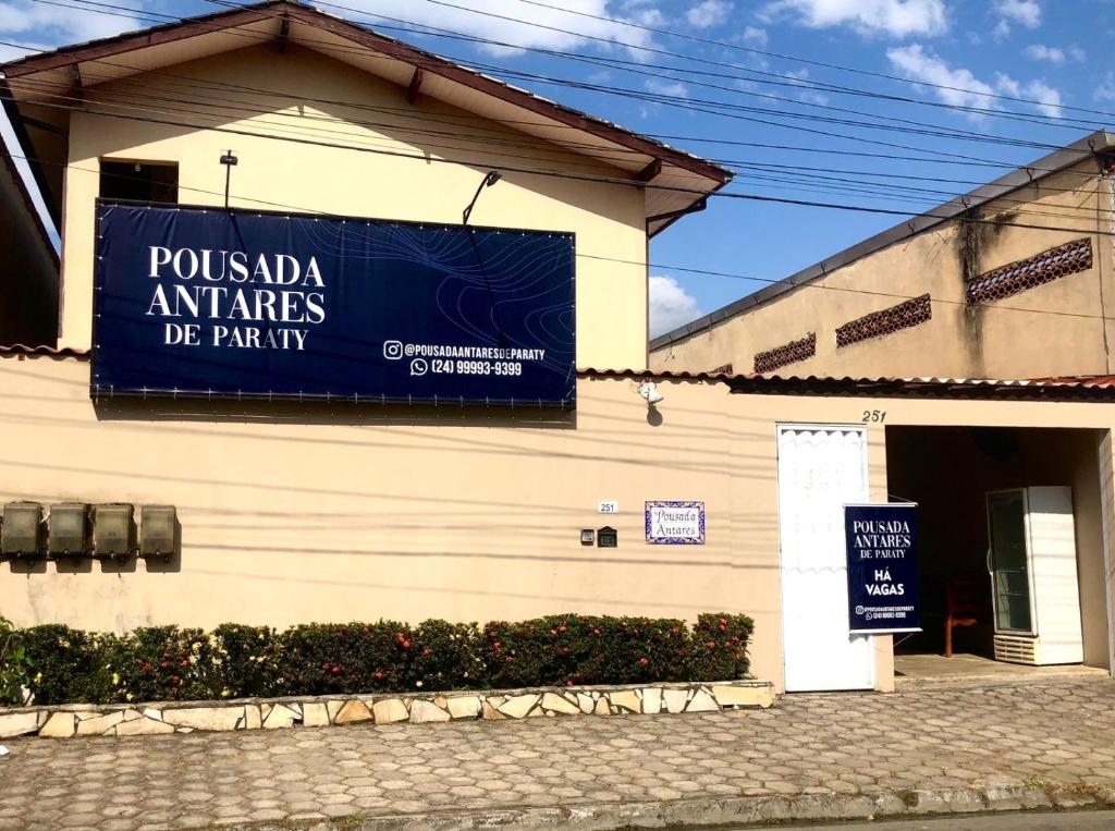 a building with a blue sign on the side of it at Pousada Antares de Paraty in Paraty