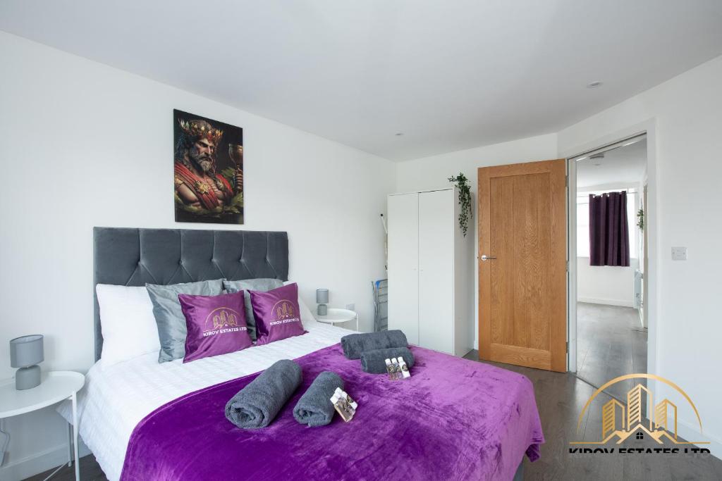 a bedroom with a purple bed with purple sheets at Dionysus Apartment - The Celebration of Town in Southampton