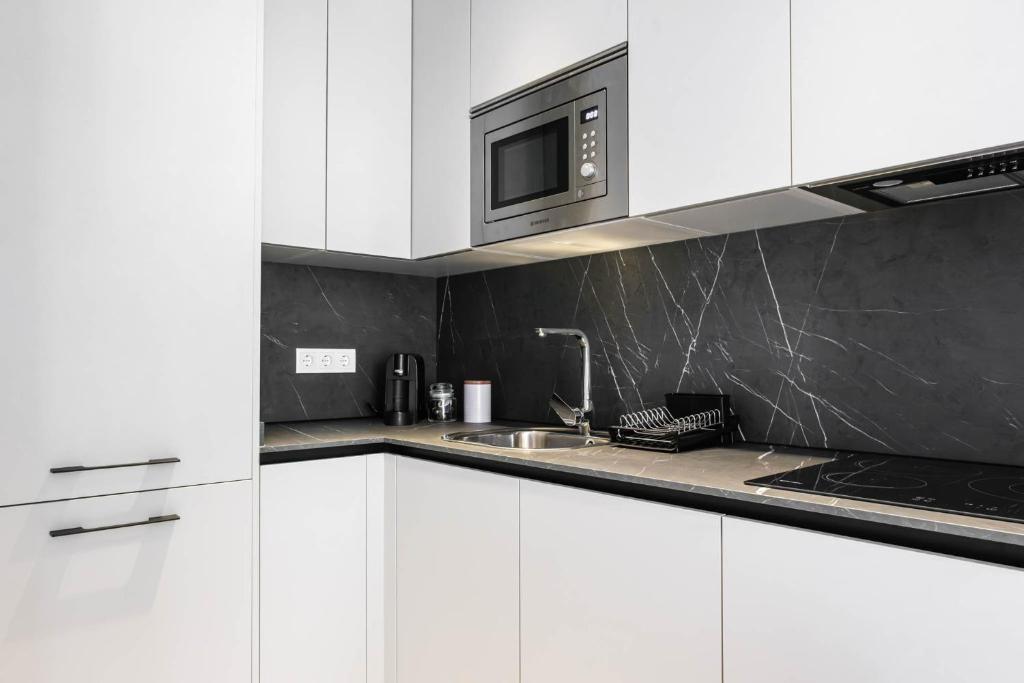 Kuchyň nebo kuchyňský kout v ubytování Apartamentos El Reloj