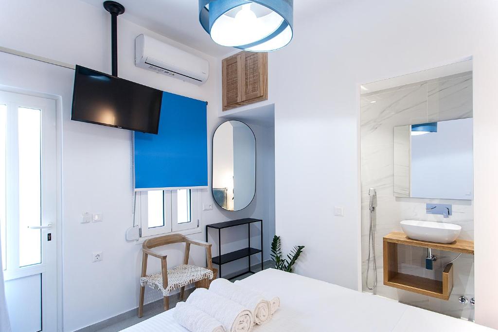 a white bathroom with a bed and a sink at Georgia apartments in town in Skiathos