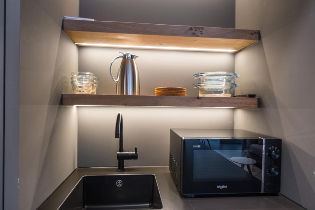 A cozinha ou kitchenette de Belcasa Suitehotel