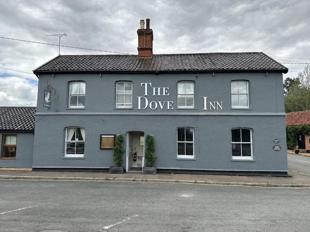 un edificio azul con la posada de las palomas escrita en él en The Dove Inn en Alburgh