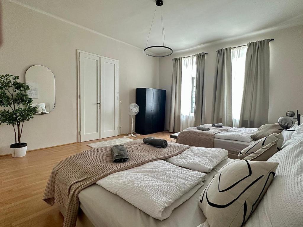 a bedroom with two beds and a large window at Stylish Apartment, next to Schloss Belvedere in Vienna