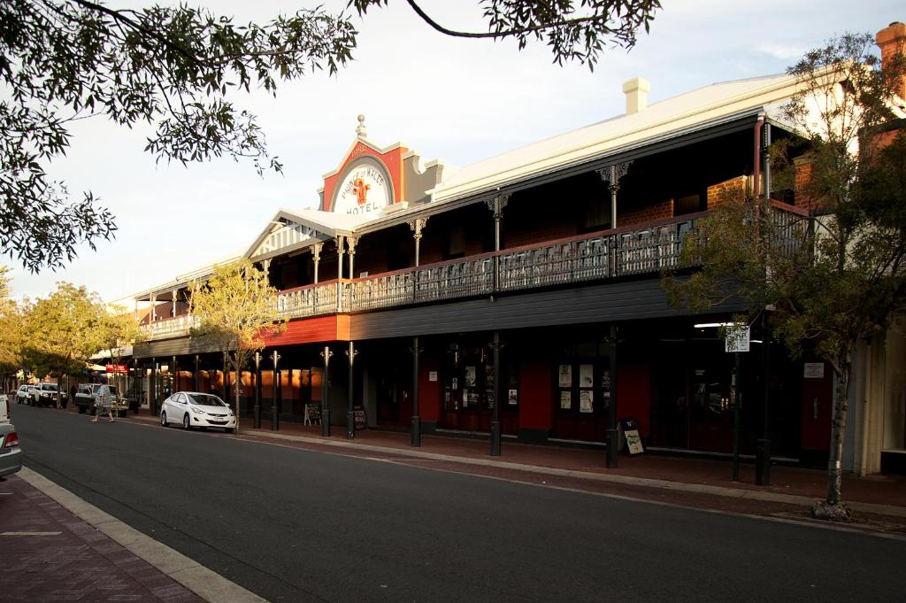 a large building with a clock on the side of it at Prince of Wales Hotel, Bunbury in Bunbury