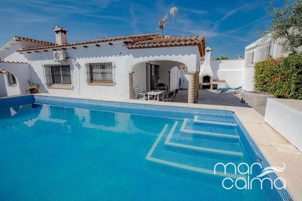 a villa with a swimming pool in front of a house at Villa Rustical by MarCalma in Bonmont Terres Noves