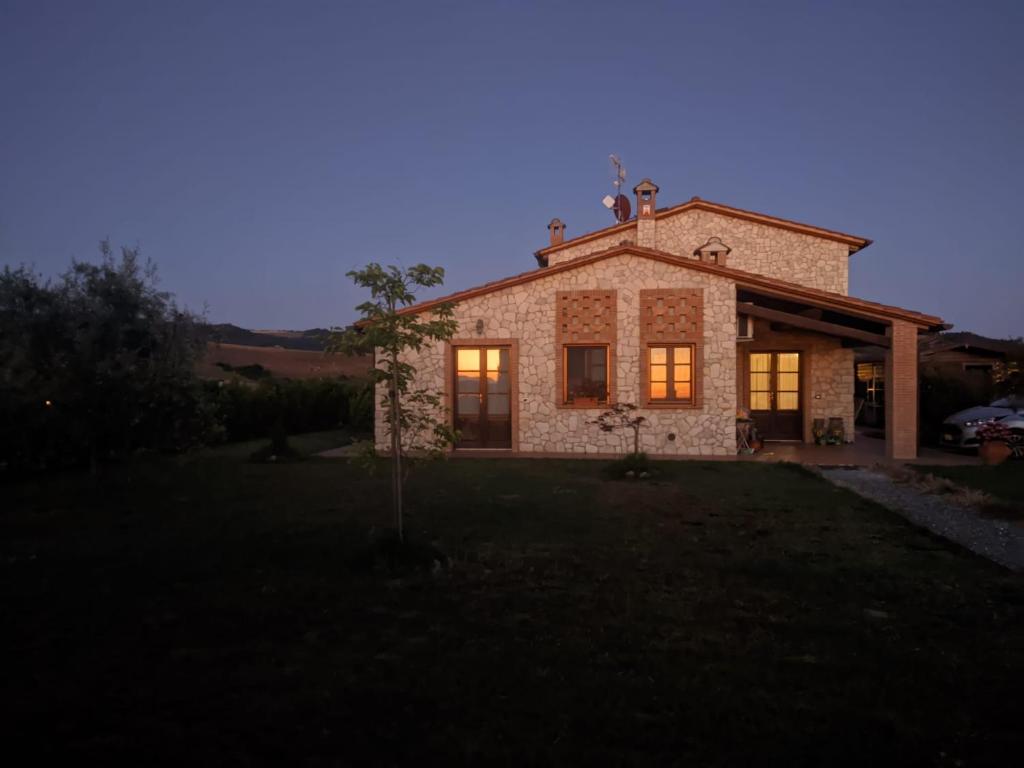 een huis met lichten aan in de tuin bij Il poggio più 'n giù in Volterra