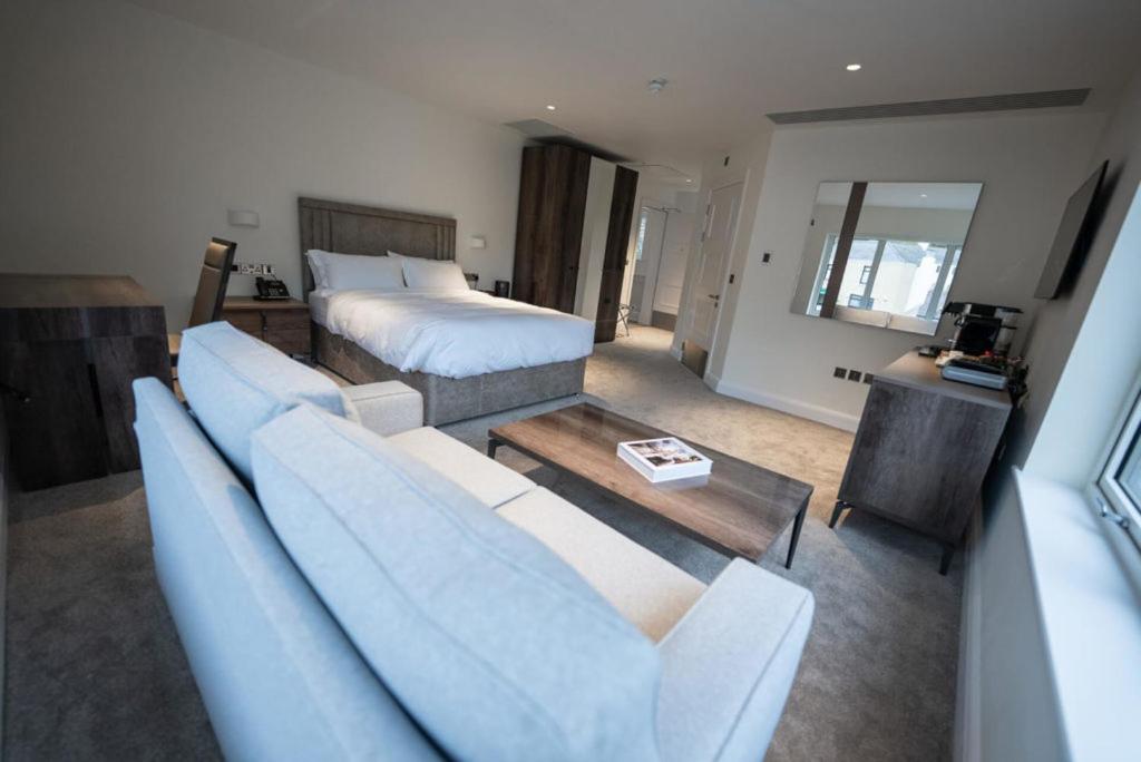 a living room with a couch and a bed at Shore Hotel Laxey in Laxey