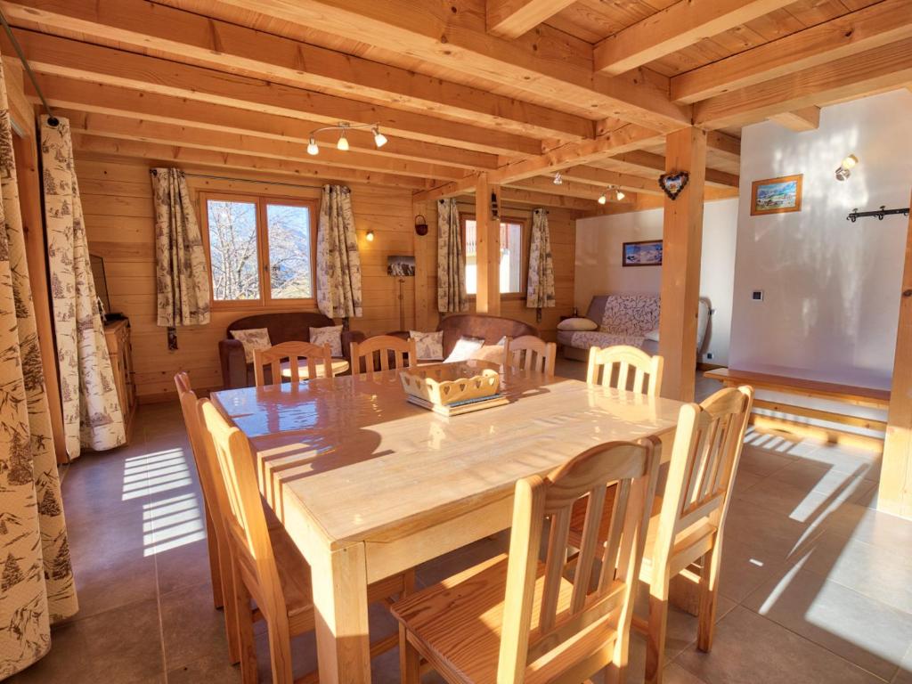 a dining room with a wooden table and chairs at Chalet typique, 4 chambres, vue montagne, WIFI, parking - FR-1-505-66 in Notre-Dame-de-Bellecombe