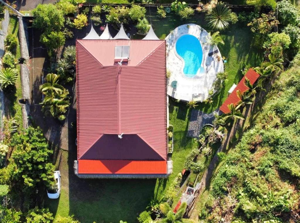 an overhead view of a house with a swimming pool at Vaikea Fare in Mahina