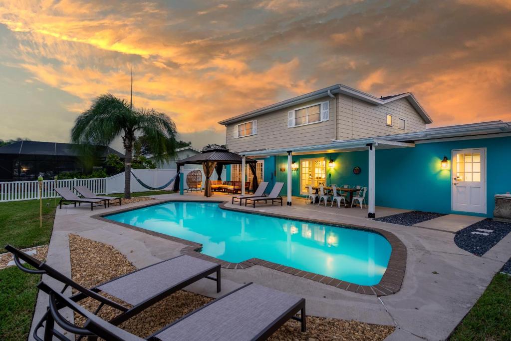 a swimming pool in front of a house at Ultimate Waterfront Oasis Heated Pool & Boat Dock in Tampa