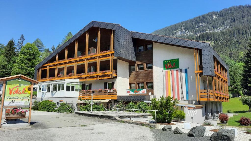 ein großes Gebäude mit einem Schild davor in der Unterkunft Hotel Vital Bad Bleiberg in Bad Bleiberg