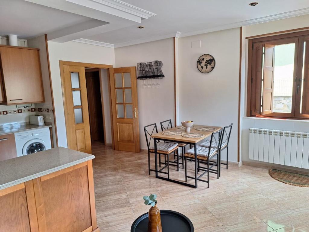 a kitchen and dining room with a table and chairs at La Santina y su Jardín in Avilés