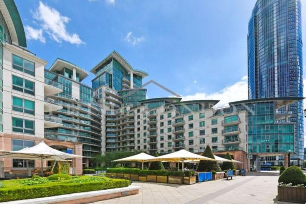 a large building with some umbrellas in front of it at Vauxhall large 2bedroom Central London with amazing River View Panoramic Balcony in London