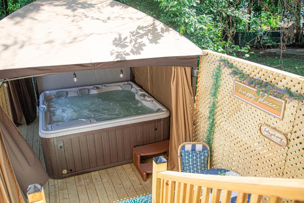 a hot tub in the back of a tent at Your Cozy and Relaxing Retreat in Woburn