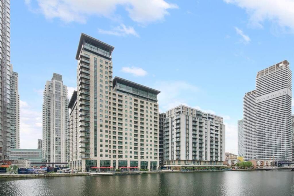 a group of tall buildings next to a body of water at Spacious Two Bedroom Apartment in London