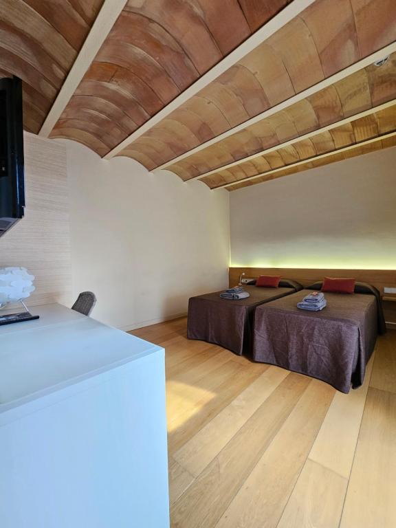 Postel nebo postele na pokoji v ubytování Hotel Can Bo De Pau