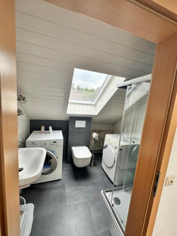 a bathroom with a sink and a washing machine at Ferienhaus Seepark Kirchheim in Kirchheim