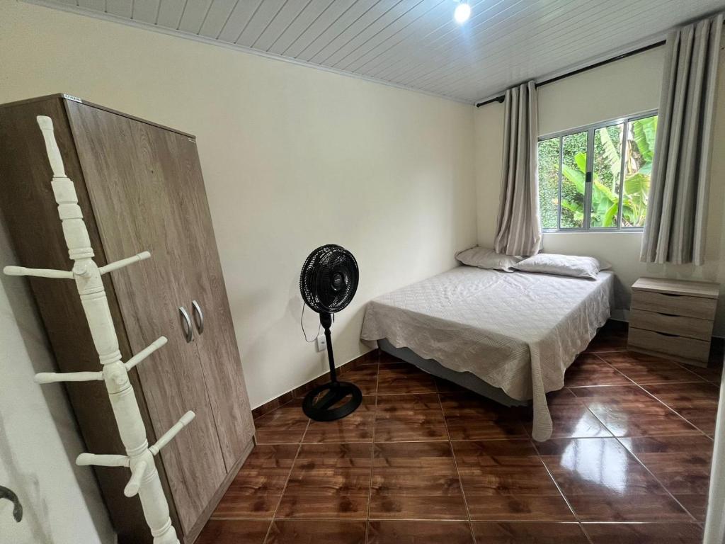una camera con letto e ventilatore a pavimento di Casa em Ilha Grande - João da Mariana ad Angra dos Reis