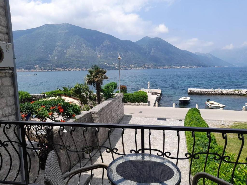 a balcony with a view of the ocean and mountains at Summer Apartment in Kotor