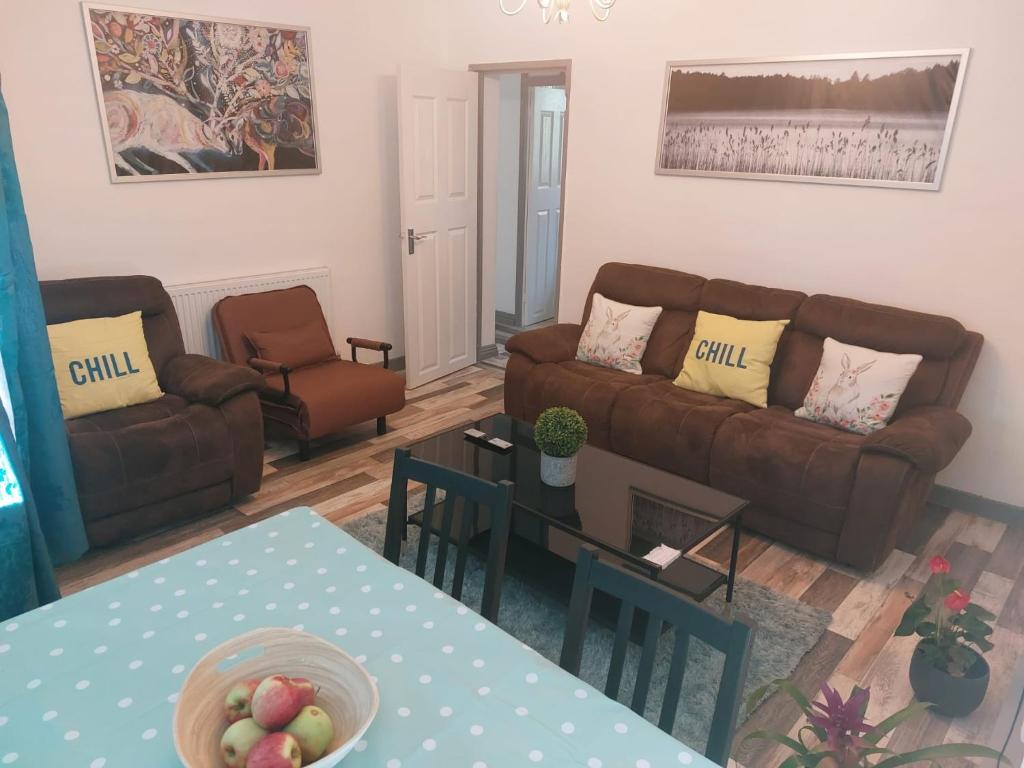 a living room with two couches and a table at Holiday villa in London