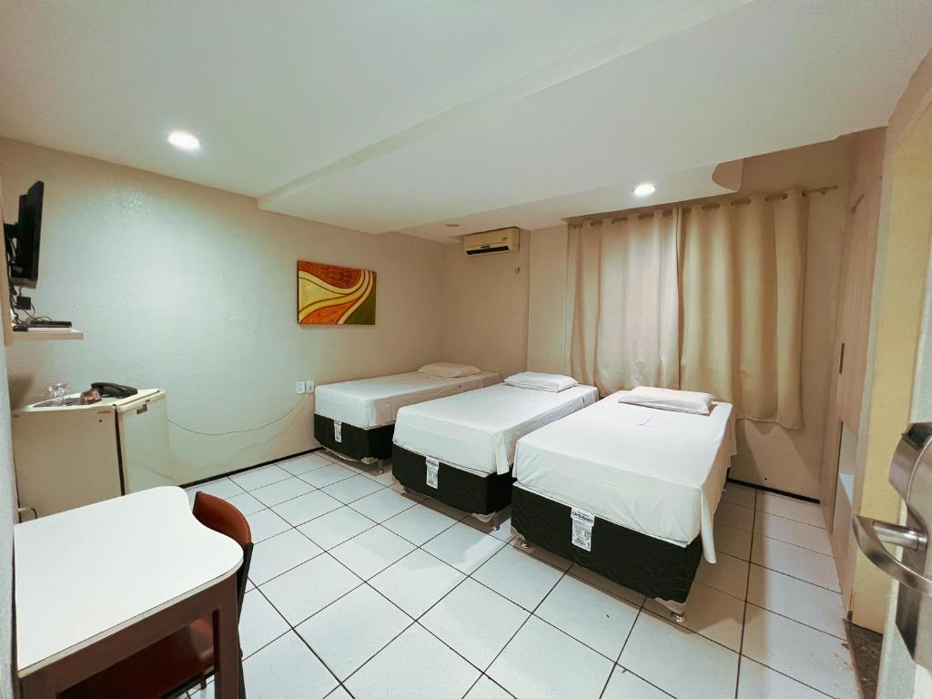 Ένα ή περισσότερα κρεβάτια σε δωμάτιο στο Hotel Visconde