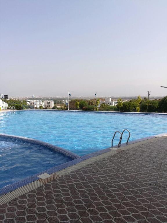 a large swimming pool with blue water in a city at Cabo Dream a Cabo Negro in Cabo Negro