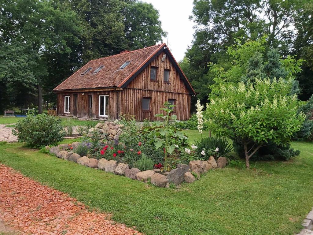 a small wooden house with a garden in front of it at Holiday house Elsa Linden 