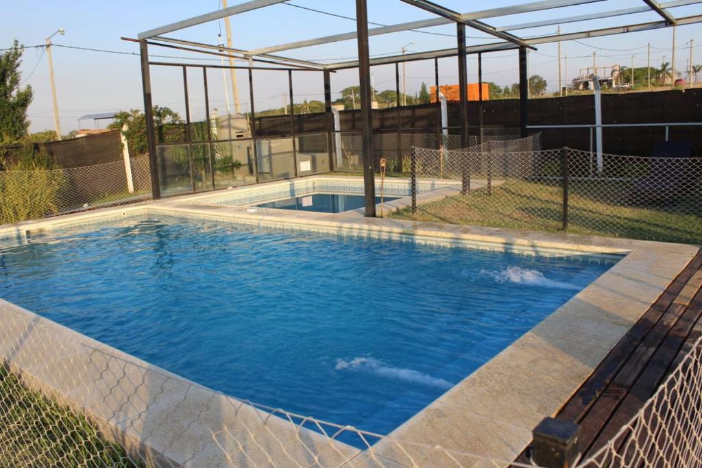 a swimming pool with a fence around it at Cabañas Santa Rita in San Pedro