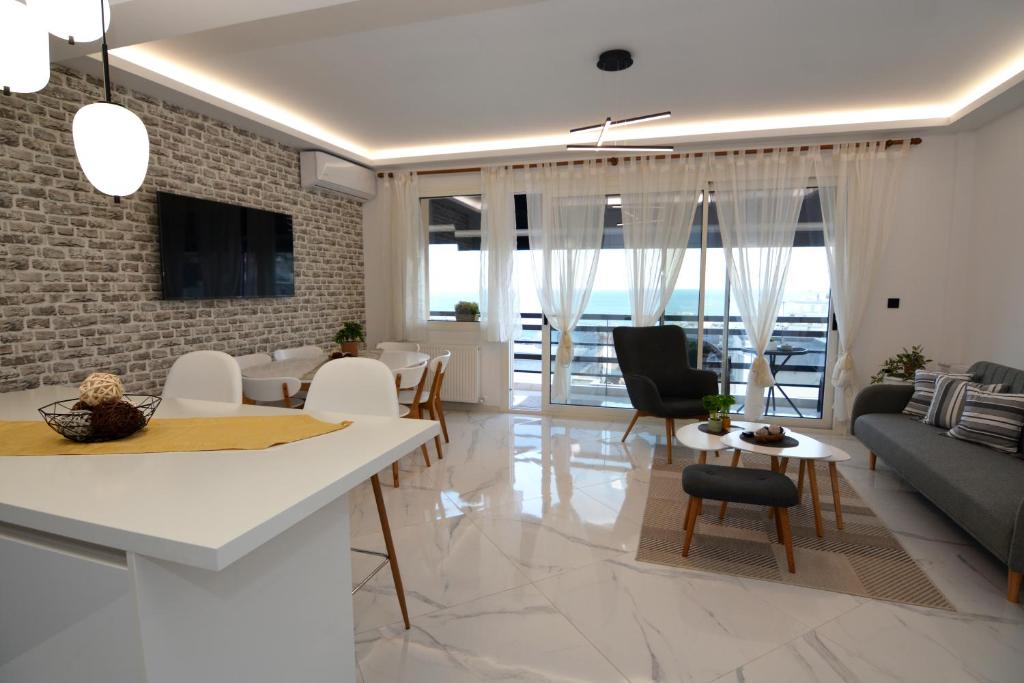 a kitchen and living room with a brick wall at La Casa Blanca in Kavála